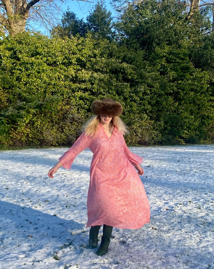 Sunni is an ultra luxurious, organic pure cotton nightie with bell sleeve in pink glow with orange. It is invariably mistaken for silk.   Extremely comfortable and light and feels beautiful to sleep in - the moment you put it on, it feels heavenly.   Elegant, ethereal and so pretty with a pretty neckline and gorgeous bell sleeve  The model is usually a size 8 but seen here in our size 12 sample   Superb workmanship and has been produced in a happy workshop well known to us under excellent working conditions