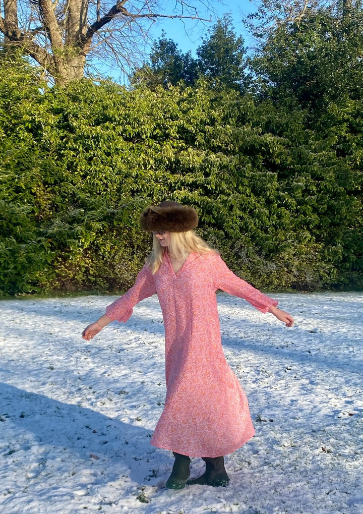 Sunni is an ultra luxurious, organic pure cotton nightie with bell sleeve in pink glow with orange. It is invariably mistaken for silk.   Extremely comfortable and light and feels beautiful to sleep in - the moment you put it on, it feels heavenly.   Elegant, ethereal and so pretty with a pretty neckline and gorgeous bell sleeve  The model is usually a size 8 but seen here in our size 12 sample   Superb workmanship and has been produced in a happy workshop well known to us under excellent working conditions