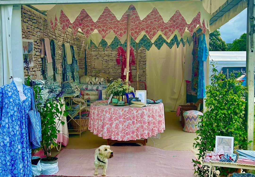 The Parasol-UK stand at Mars Badminton Horse Trials 2025 with Terrier Lettice in the foreground and the Parasol-UK Luxury Garden Parasols behind
