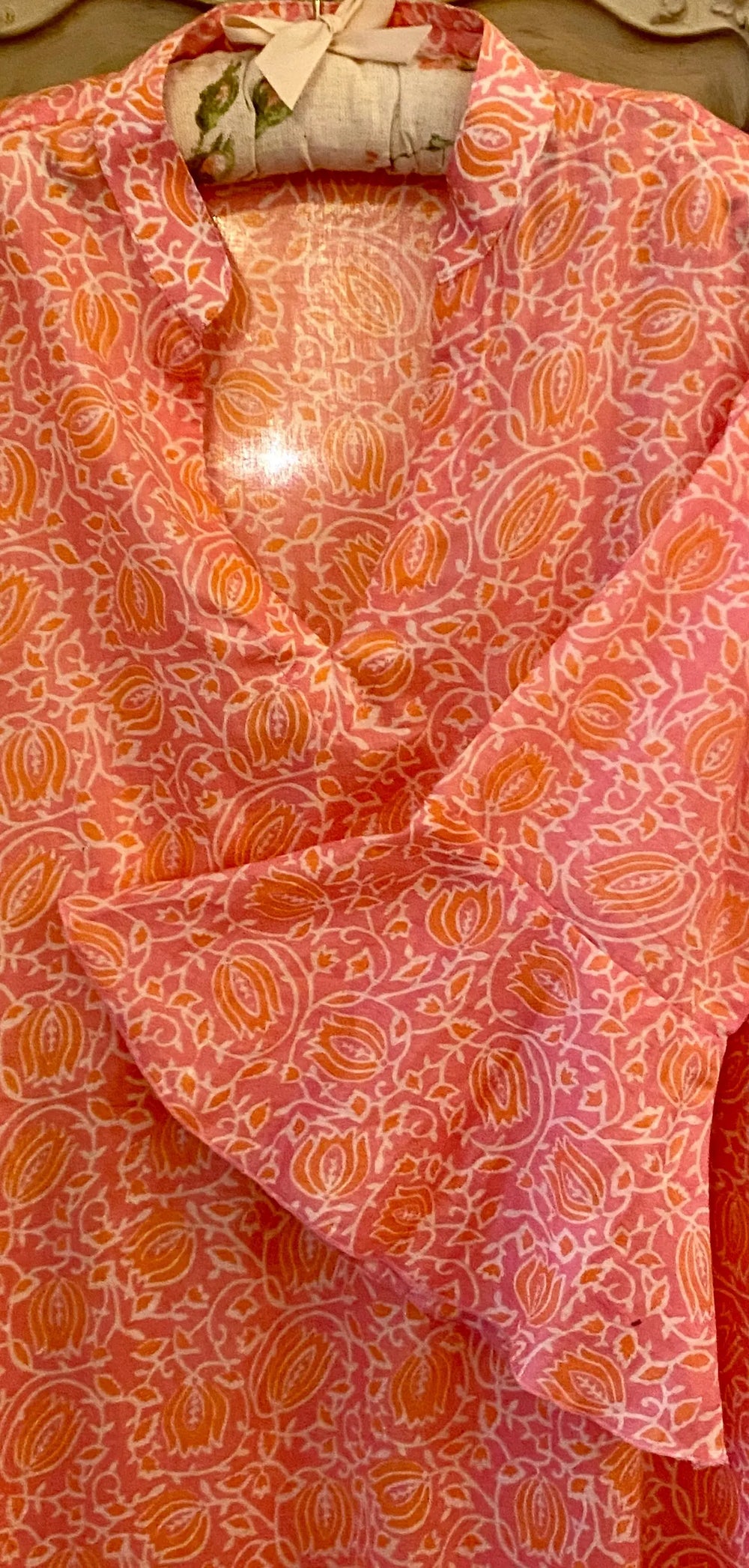 Sunni is an ultra luxurious, organic pure cotton nightie with bell sleeve in pink glow with orange. It is invariably mistaken for silk.   Extremely comfortable and light and feels beautiful to sleep in - the moment you put it on, it feels heavenly.   Elegant, ethereal and so pretty with a pretty neckline and gorgeous bell sleeve  The model is usually a size 8 but seen here in our size 12 sample   Superb workmanship and has been produced in a happy workshop well known to us under excellent working conditions