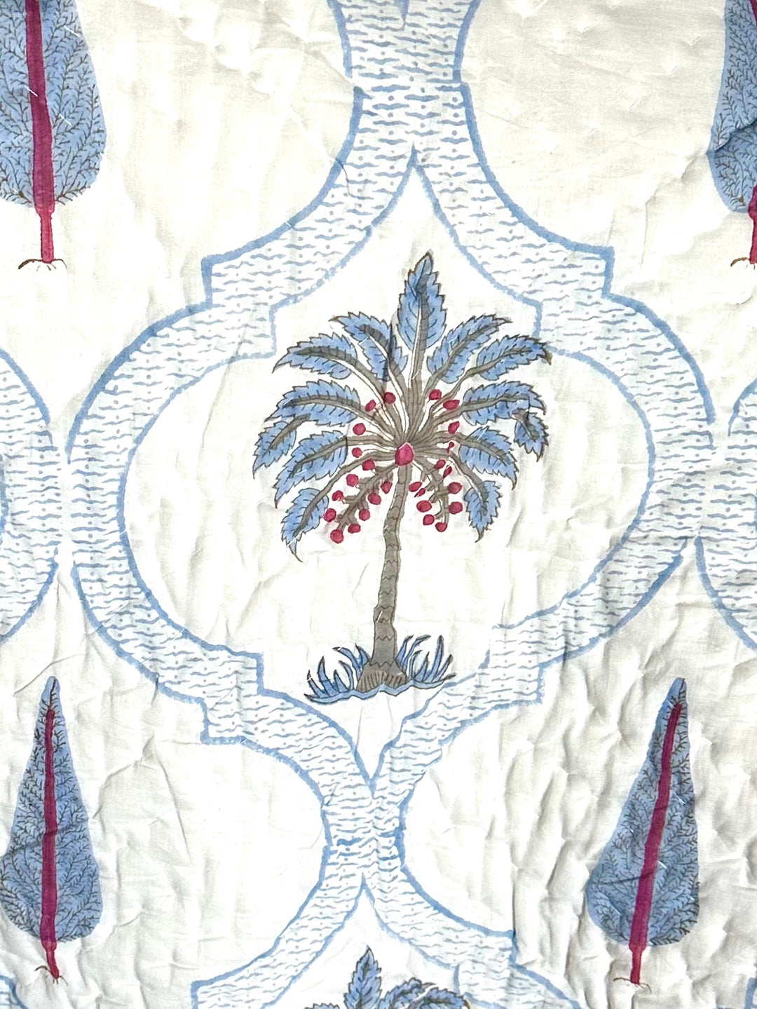 Patterned fabric with embroidered palm trees and geometric shapes