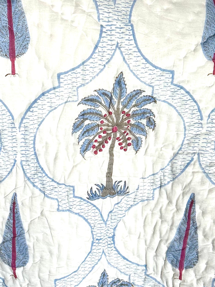 Patterned fabric with embroidered palm trees and geometric shapes